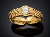 a close up of a gold ring with a diamond in the center