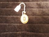 a picture of a pair of earrings with a tag on them