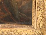 a painting of a woman reading a book in a gold frame