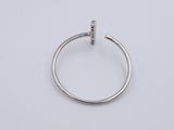 a close up of a silver ring on a white surface