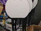 three chairs and a table in a cluttered room