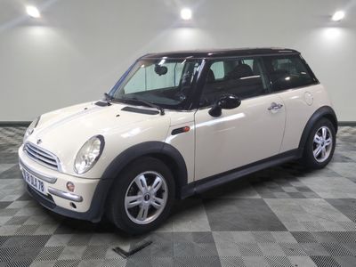 a picture of a white mini cooper parked on a checkered floor