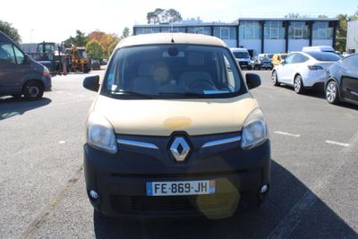 yellow and black van parked in a parking lot next to other cars