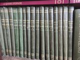many books that are on a shelf in a library