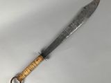 a close up of a knife with a wooden handle on a white surface
