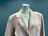 a white mannequin with a pink jacket on a mannequin stand