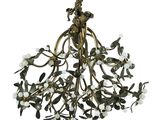 a brass chandelier with flowers and leaves hanging from the ceiling