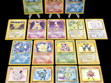 a lot of pokemon cards that are on the table
