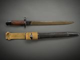 two knives are shown on a gray surface with a black background
