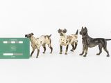 three figurines of dogs and a credit card on a white surface