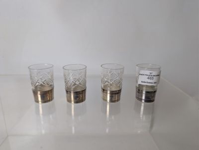 four glasses sitting on a table with labels on them