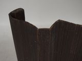 a close up of a wooden vase on a table