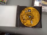 a yellow cd in a case on a table