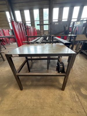 the table is made of wood and has wheels on it
