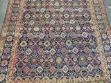 an antique persian rug with blue and red colors