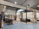 a photo of a room with curtains and tables in it