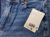 the back of a pair of blue jeans with a tag on it