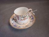 a cup and saucer sitting on a table