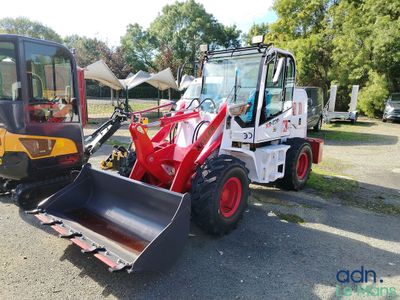 a picture of a tractor and a bulldozer parked in a parking lot