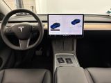 the interior of a car with a laptop and a steering wheel