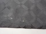 a black piece of cloth with a small patch on it