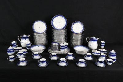 a lot of blue and white dishes and cups on a table
