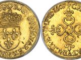 a gold coin with a crown on top of it