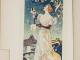 an old poster of a woman in a white dress is hanging on a wall