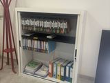 a book shelf with books on it in the corner of a room