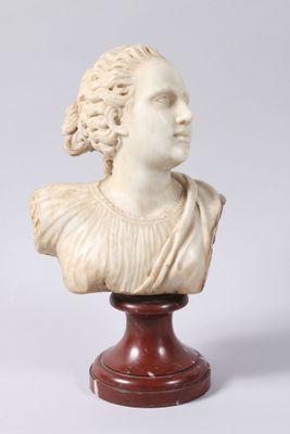 a white marble bust of a woman on a wooden stand