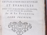 an old book with writing on it sitting on a table