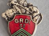 a badge with a horse and rider on it on a table