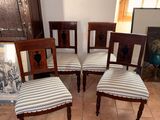 four chairs that are sitting on a tile floor