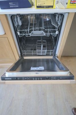 a dishwasher that is open in a kitchen