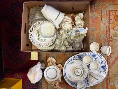 a box full of dishes and cups on the floor