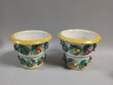 pair of yellow and white vases with flowers on them