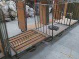 a metal bed with a wooden platform in the middle of a warehouse