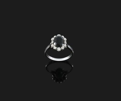 a black and white diamond ring on a black surface