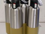 three stainless steel water bottles are lined up on a white surface