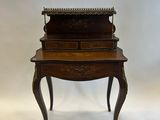 an antique writing desk with a drawer on top of it