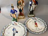 several figurines of soldiers are displayed on plates on a table