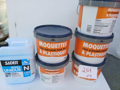 five buckets of paint sitting on a table next to a container of glue