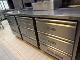 a kitchen with a lot of drawers and a stove