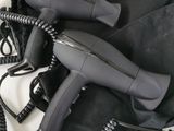a black blow dryer sitting on top of a black bag