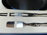 two forks and a pan sitting on a table