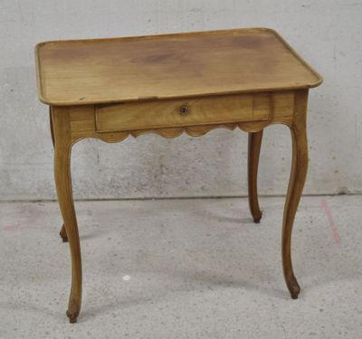 a small wooden table with a drawer on it