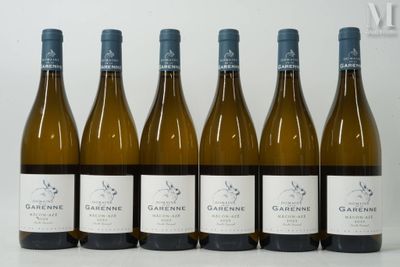 six bottles of wine are lined up in a row on a table