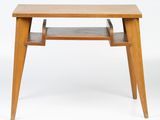 a close up of a small wooden table with a shelf on it
