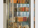 a glass display case with many books on it