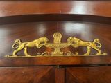a wooden cabinet with two lions on top of it